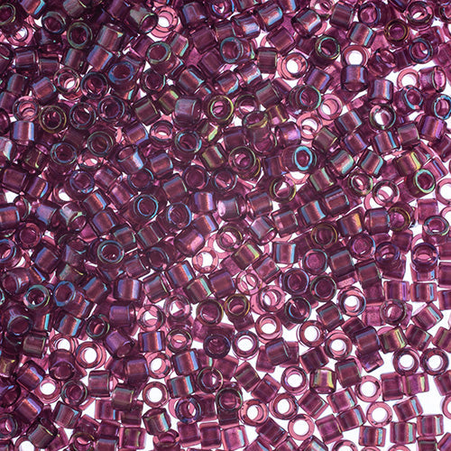 Close-up of Miyuki Delica 11/0 DB1747 cylinder beads in fuchsia lined amethyst with an AB rainbow finish