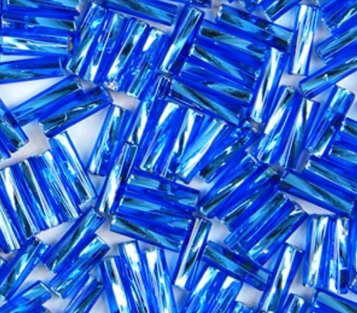 Close-up of loose twisted 6mm Preciosa Czech glass bugle beads in silver-lined dark aqua