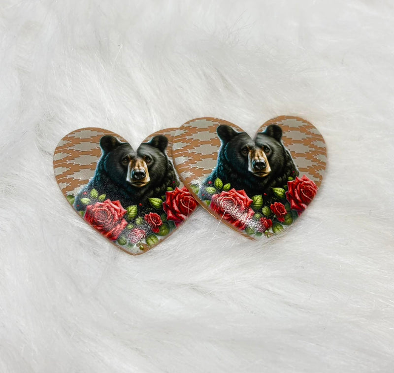 Pair of 37mm resin heart cabochons (cabs) with a black bear among red roses on a tan patterned background