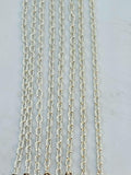 Hanging strands of 1.5mm silver stainless steel link chain against a white background