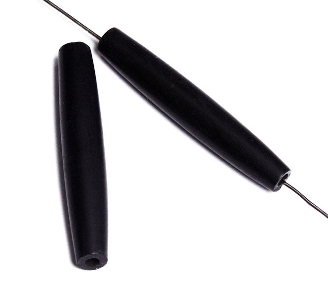 Two black 1.5 inch bone hairbone pipe beads, one threaded on a wire to show the hole