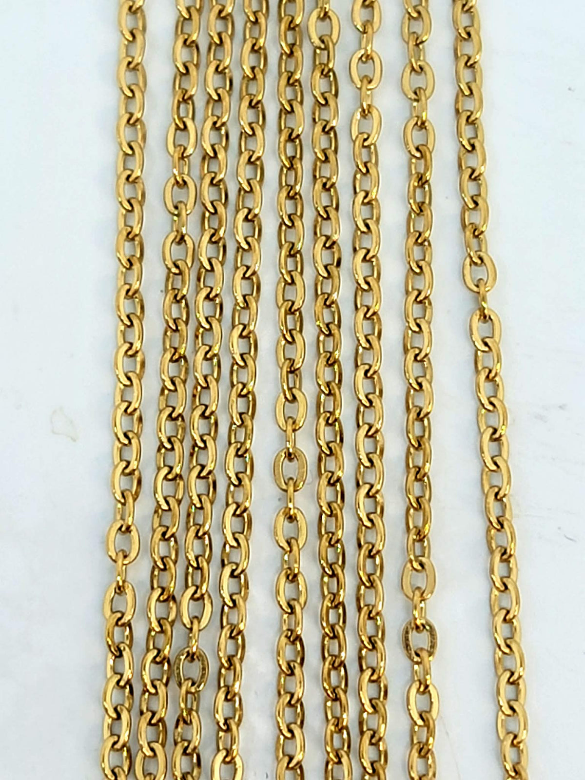 Hanging strands of 1.5 x 2mm gold stainless steel link chain
