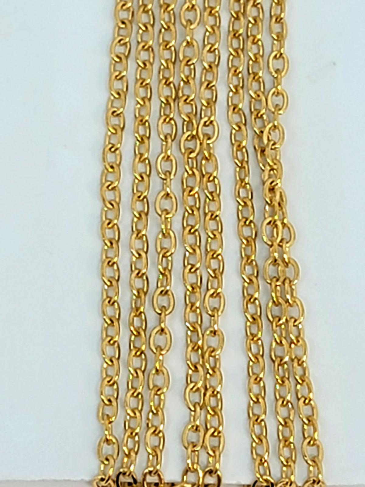 Hanging strands of 1.5 x 2mm gold stainless steel link chain