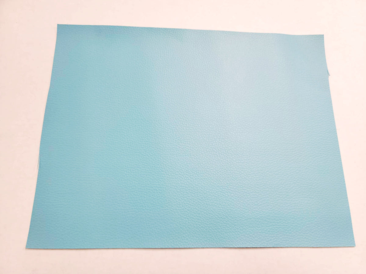 Stack of #10 blue faux leather sheets with a pebbled grain texture