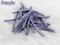 Pile of purple dyed smooth dentalium shells, about 1.5 to 2 inches long, on white faux fur
