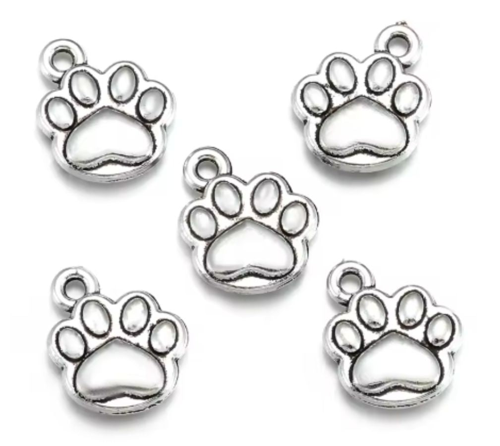 Four silver-tone 10 x 12mm paw print charms on a white background