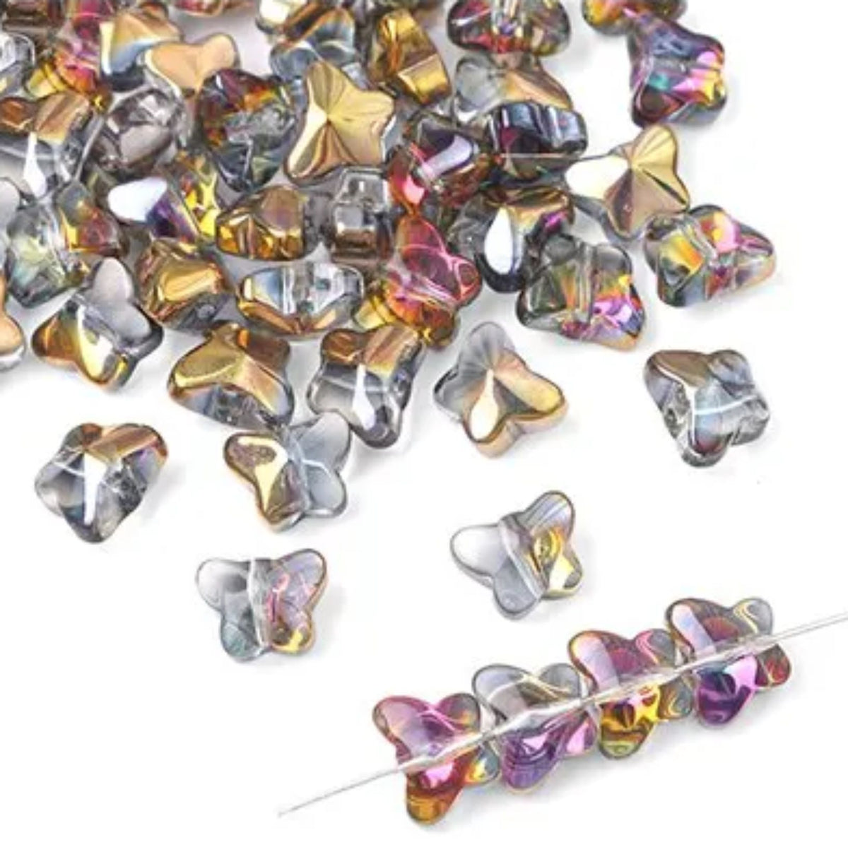 Close-up of plated glass butterfly beads in mixed gold, pink and blue