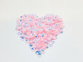 Heart-shaped pile of 6mm iridescent flower sequins in light pink