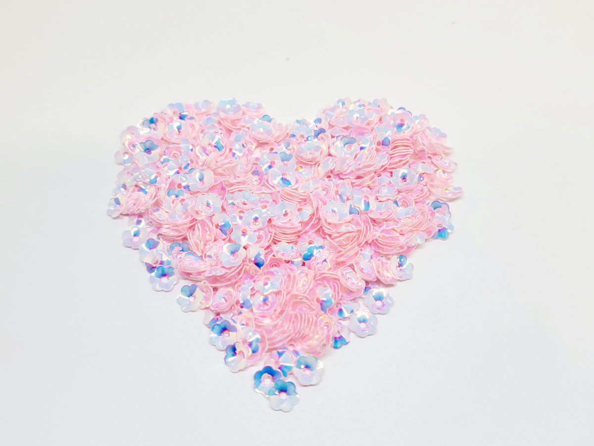 Heart-shaped pile of 6mm iridescent flower sequins in light pink