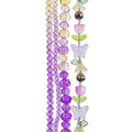 Four strands of Crystal Lane glass beads with flower, leaf and faceted round beads in a yellow to purple mix