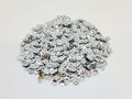 Pile of 6mm round silver sequins with centre holes, on a white background