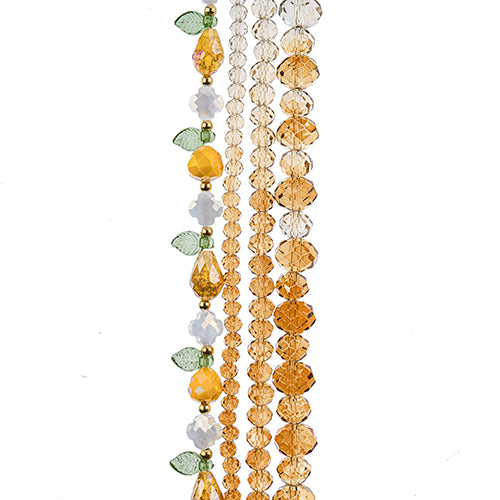 Four strands of Crystal Lane glass beads with flower, leaf and faceted round beads in a honey mix