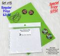 Set #15: two pairs of round floral and northern lights cabs, epoxy stickers and chain on a green sheet