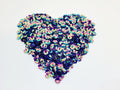 Heart-shaped pile of 6mm iridescent flower sequins in mystic purple