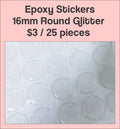 Sheet of 16mm round glitter clear epoxy dome stickers with a pink label