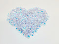 Heart-shaped pile of 6mm iridescent flower sequins in bright white