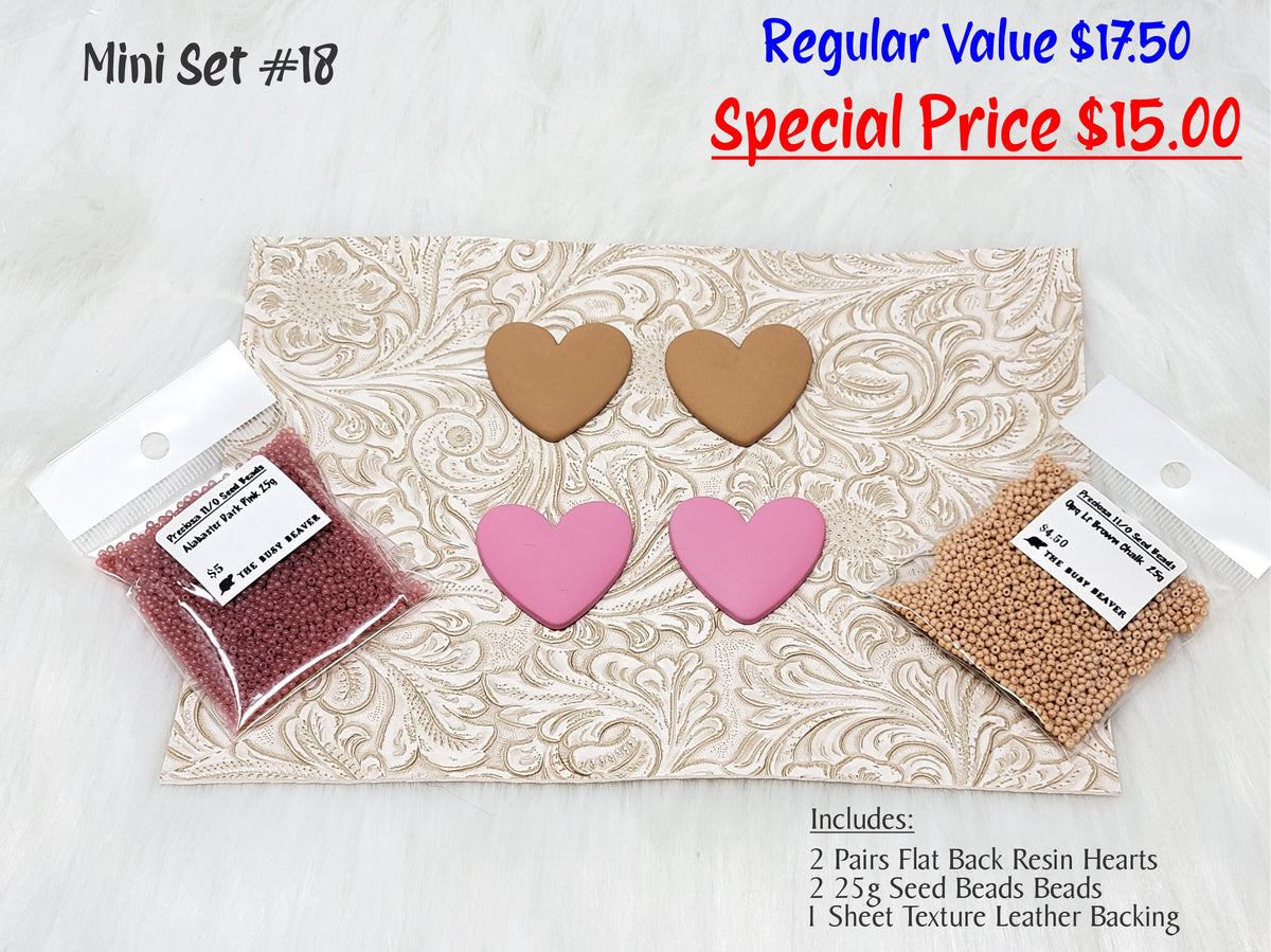 Mini set #18: tan and pink resin hearts, red and tan seed beads, and a cream tooled leather sheet
