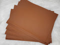 Stack of #18 brown faux leather sheets with a pebbled grain texture