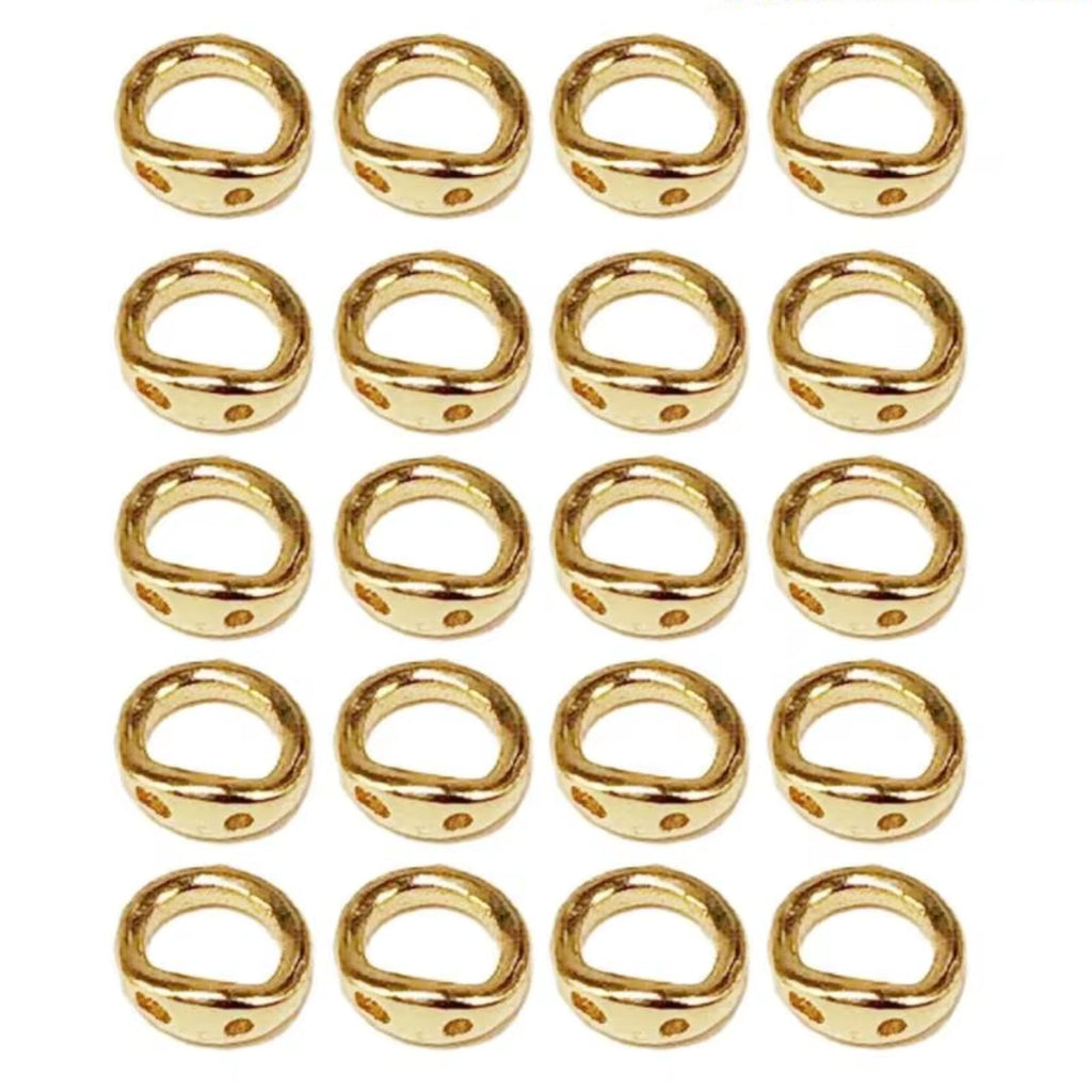 Grid of 20 18K gold double-hole connector rings, arranged in rows on a white background