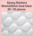 Sheet of 18 x 25mm oval clear epoxy dome stickers with a pink label