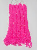 Five hanks of Preciosa 11/0 transparent neon pink seed beads laid out on a white background