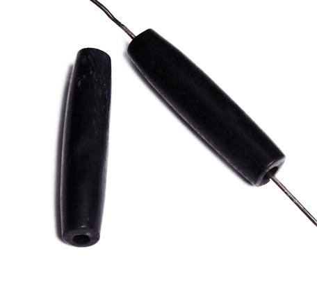 Two black 1 inch bone hairbone pipe beads, one threaded on a wire to show the hole