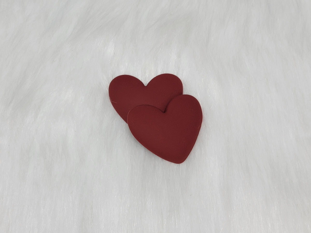 Pair of 37mm matte flexible PVC heart cabs in #1 Burgundy on white faux fur