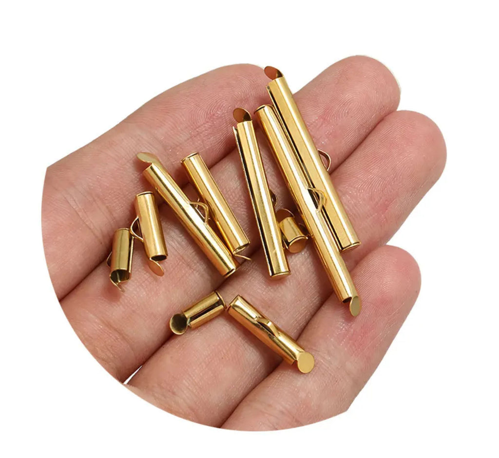 Handful of gold slide-on end clasps in several lengths, held in an open palm