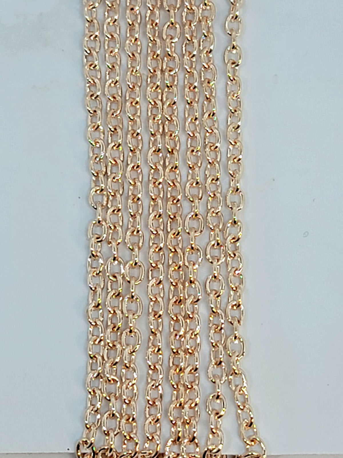 Hanging strands of 2.5 x 3.5mm rose gold stainless steel link chain