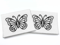 Two beading patterns printed in black on stiff white pellon squares, showing a butterfly with curled antennae