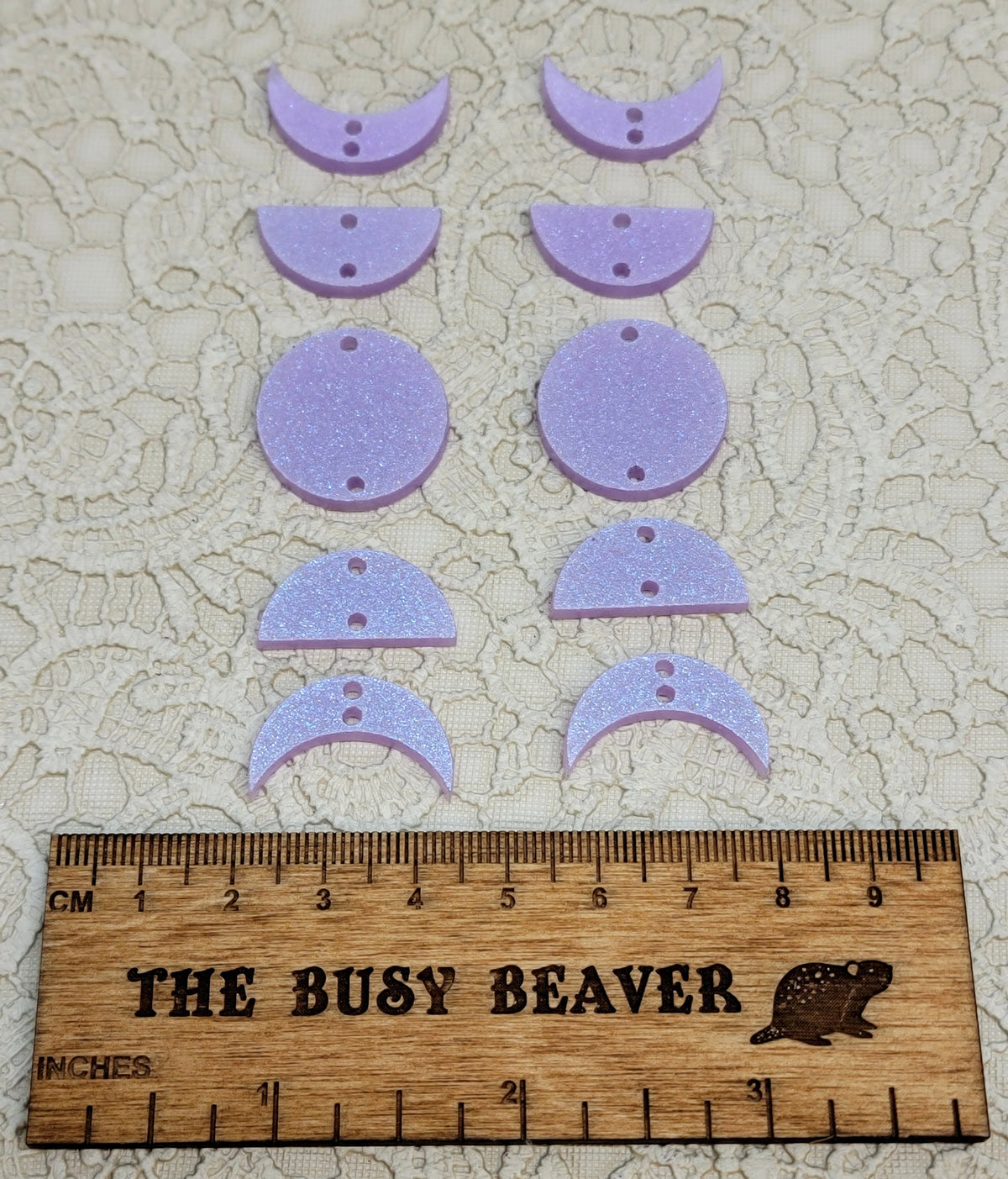 Two 5-tier acrylic moon phase sets in iridescent light purple: crescent, half and full moons beside a ruler