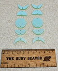 Two 5-tier acrylic moon phase sets in iridescent light green: crescent, half and full moons beside a ruler