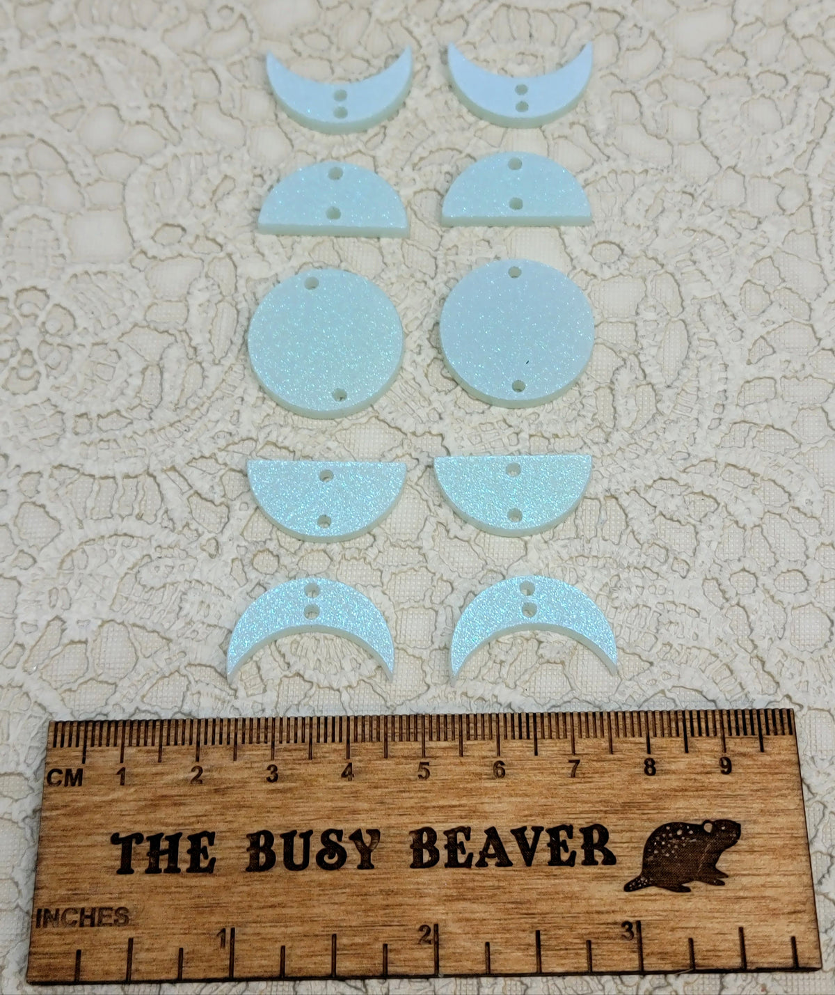 Two 5-tier acrylic moon phase sets in iridescent icy blue: crescent, half and full moons beside a ruler