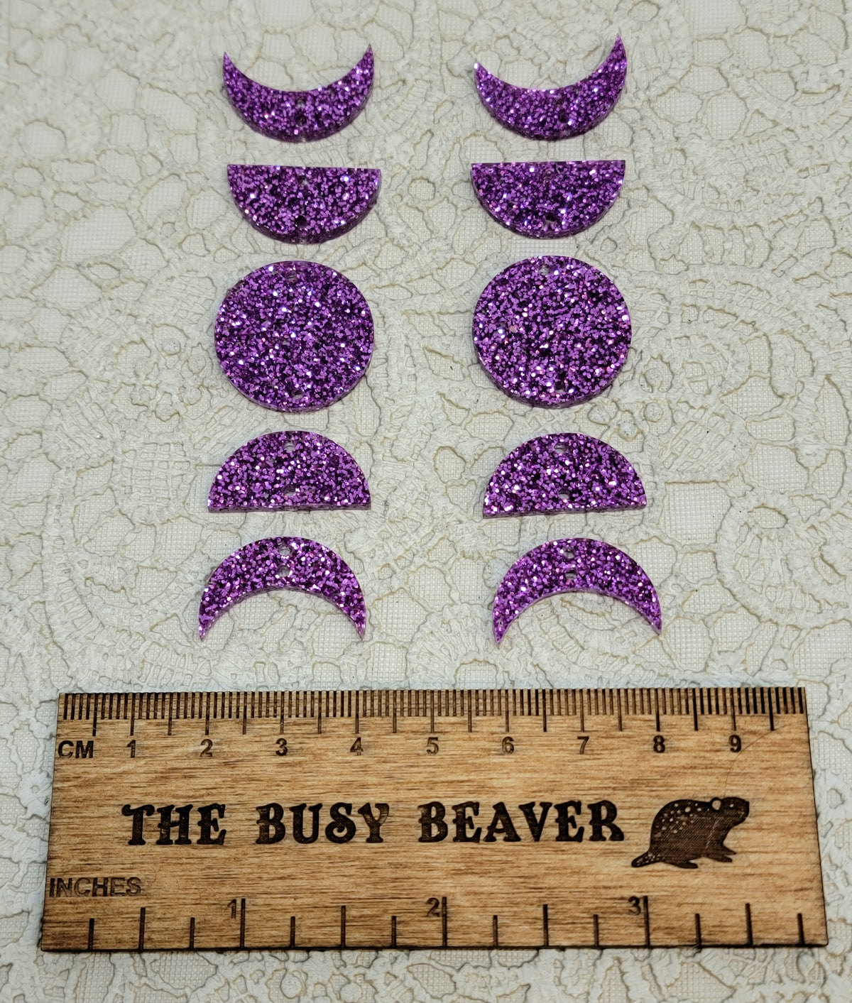 Two 5-tier acrylic moon phase sets in purple glitter: crescent, half and full moons beside a ruler