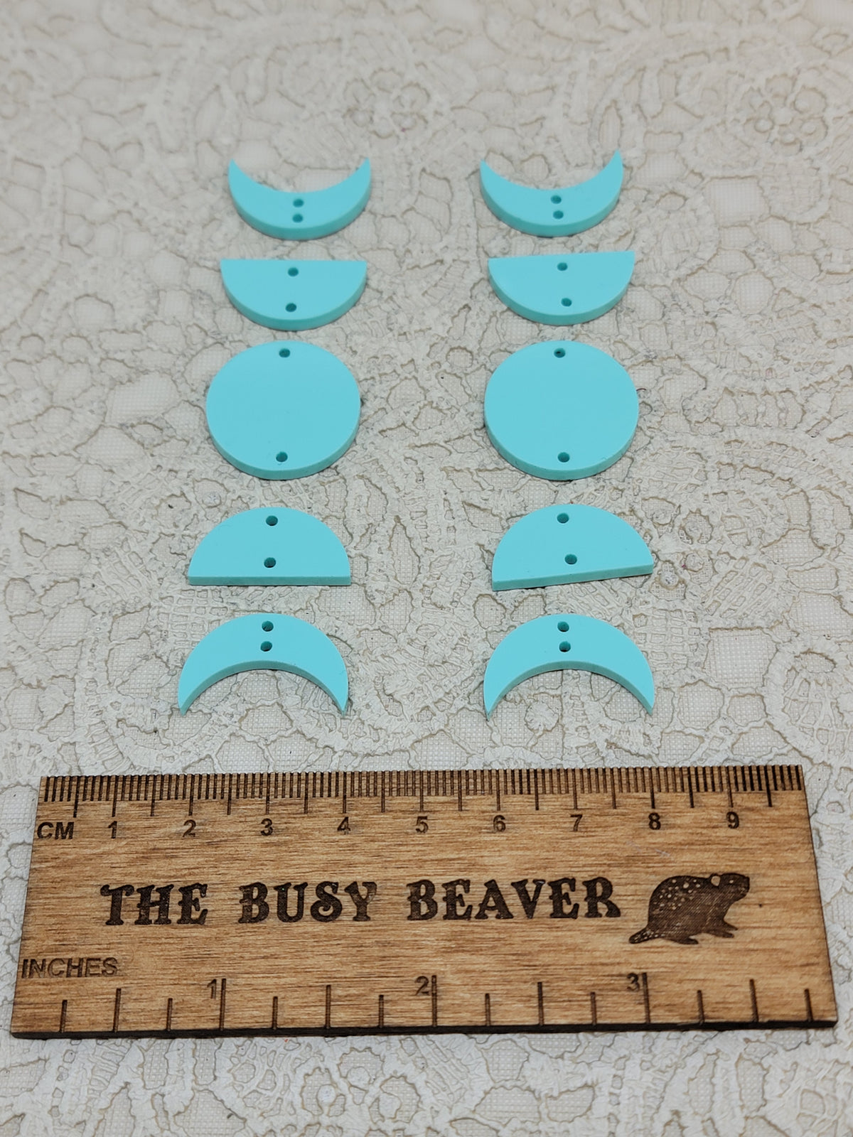 Two 5-tier acrylic moon phase sets in pastel turquoise: crescent, half and full moons beside a ruler