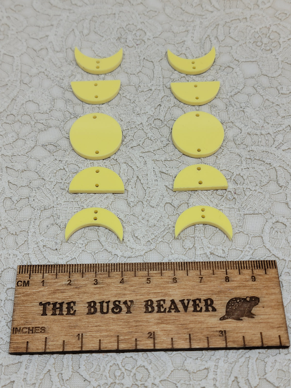 Two 5-tier acrylic moon phase sets in pastel yellow: crescent, half and full moons beside a ruler