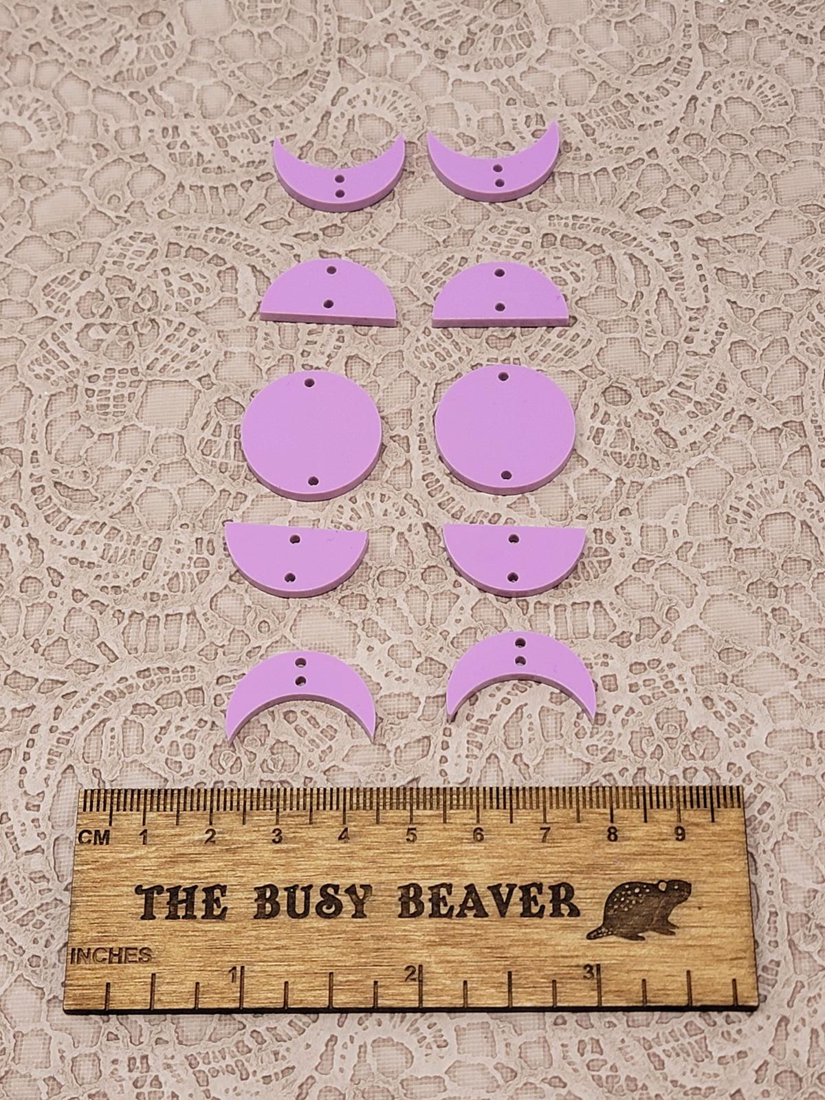 Two 5-tier acrylic moon phase sets in dark pink pastel: crescent, half and full moons beside a ruler
