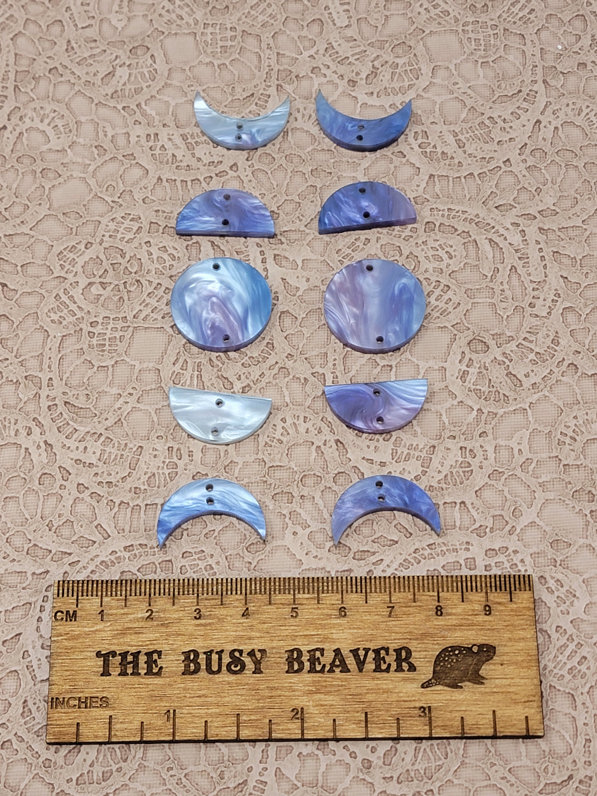 Two 5-tier acrylic moon phase sets in fuchsia/blue marble: crescent, half and full moons beside a ruler