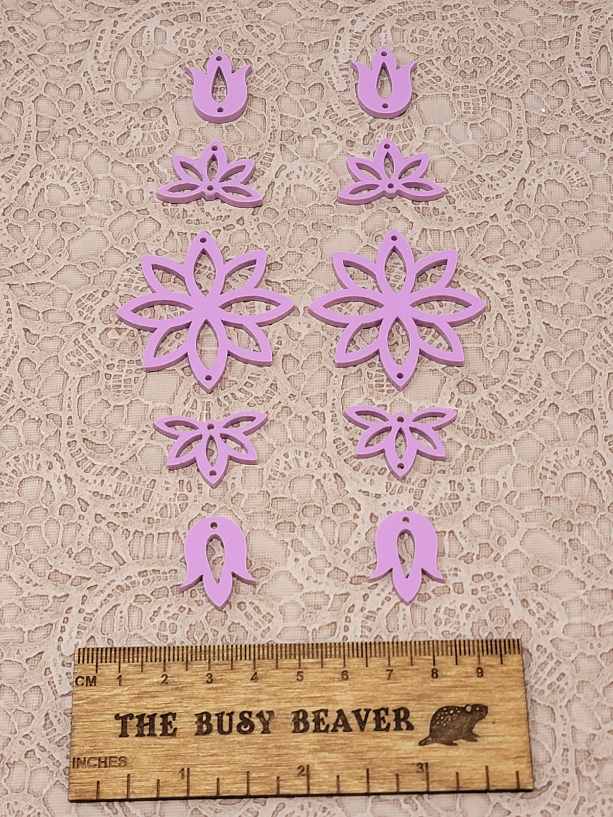 Two 5-tier acrylic flower earring sets in dark pink pastel, laid out top to bottom beside a ruler