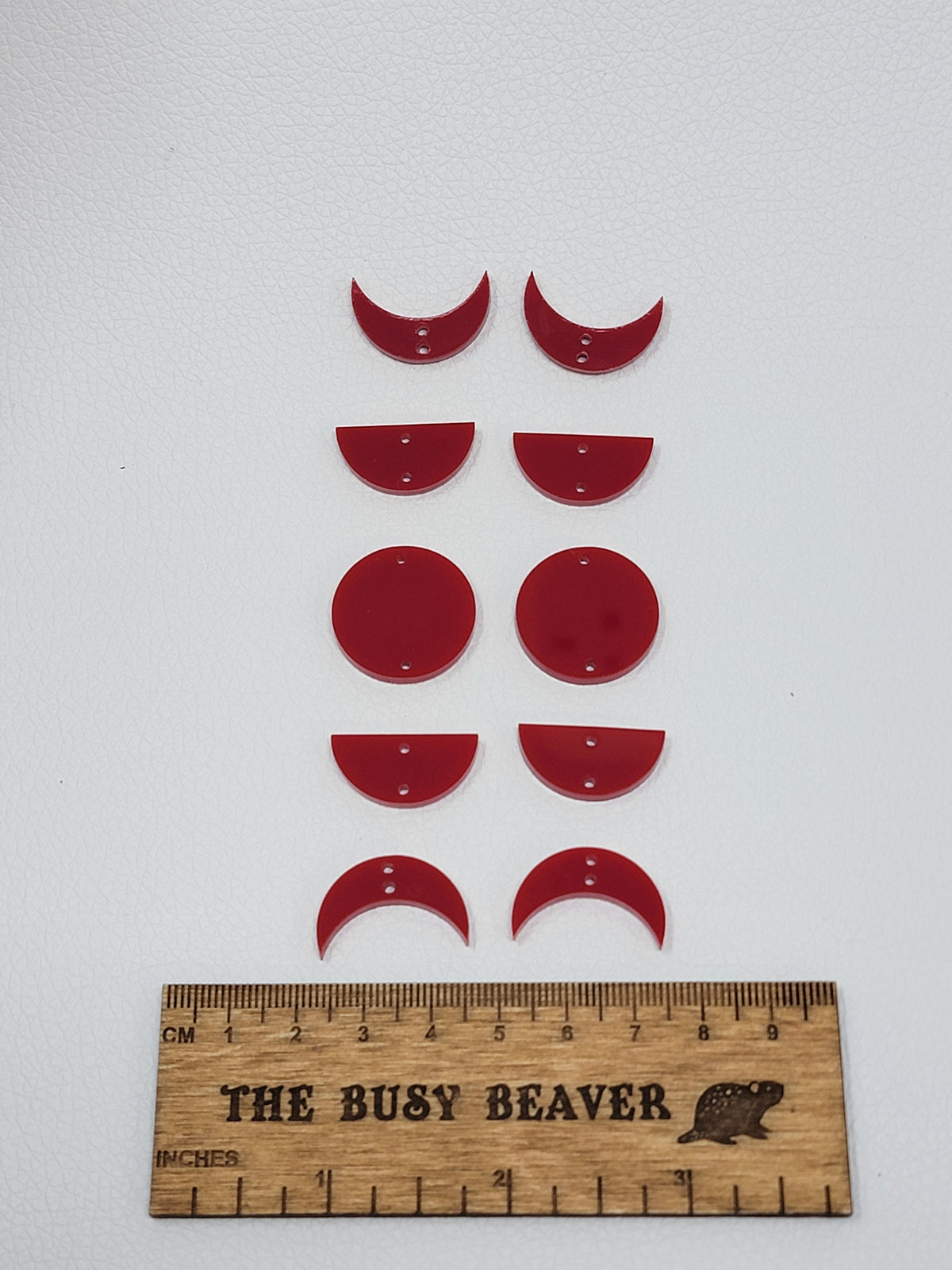 Two 5-tier acrylic moon phase sets in red: crescent, half and full moons beside a ruler