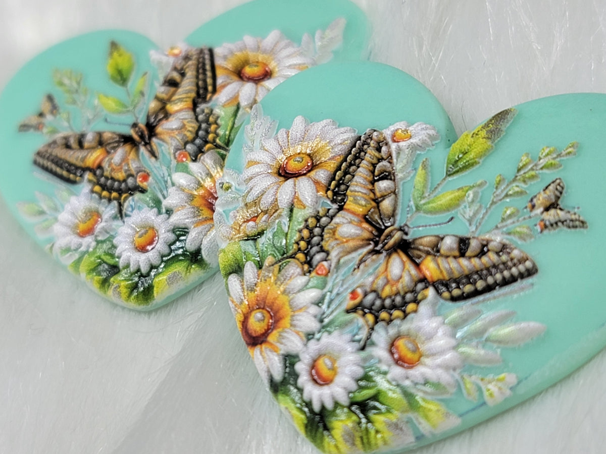 Close-up of the butterfly and daisy Premium 3D heart cabochons showing the wing detail