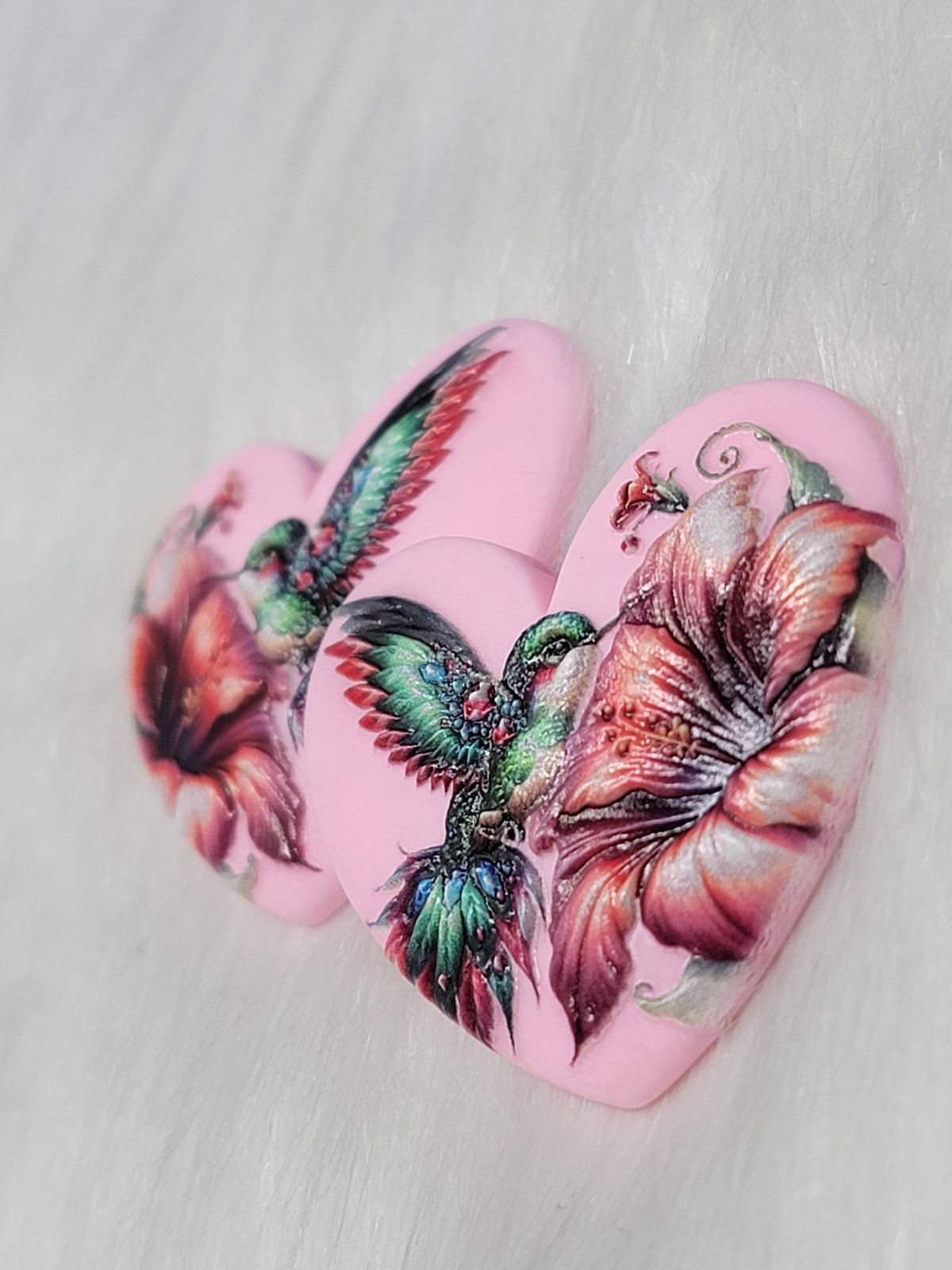 Angled close-up of the pink hummingbird Premium 3D heart cabs showing the surface detail of the bird and flower