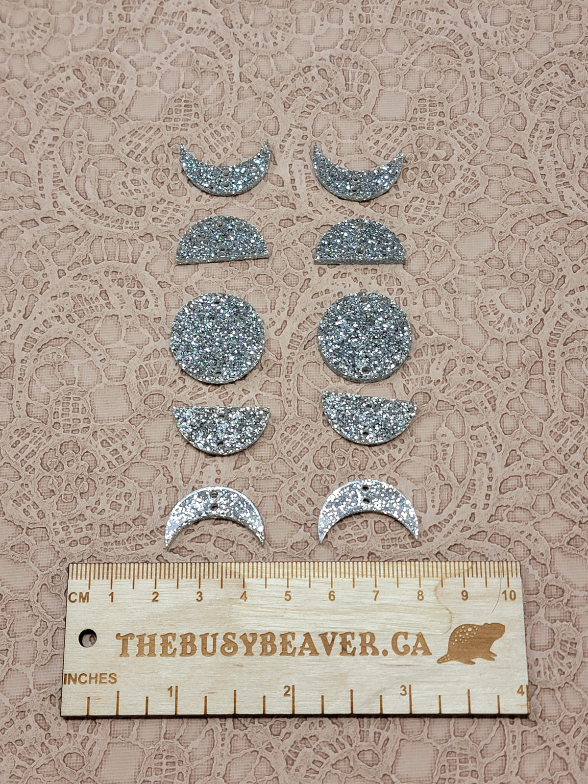 Two 5-tier acrylic moon phase sets in silver glitter: crescent, half and full moons beside a ruler