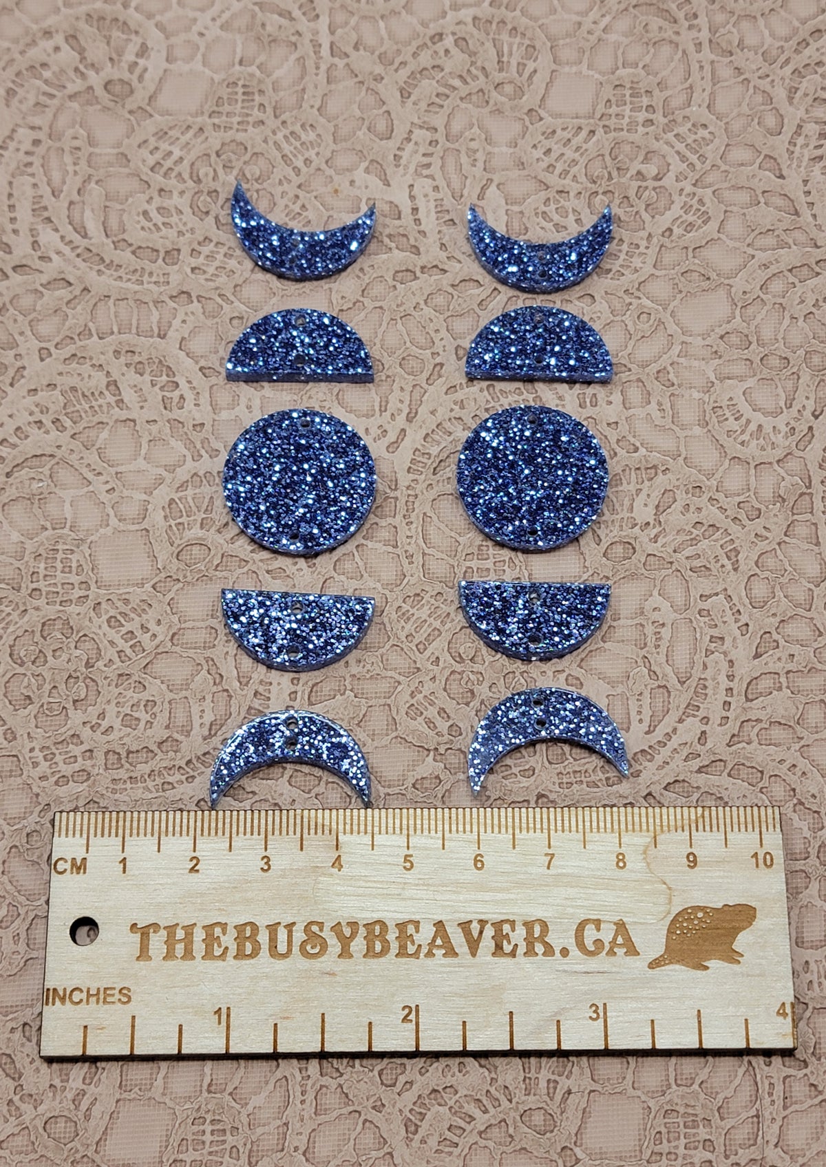 Two 5-tier acrylic moon phase sets in dark blue glitter: crescent, half and full moons beside a ruler