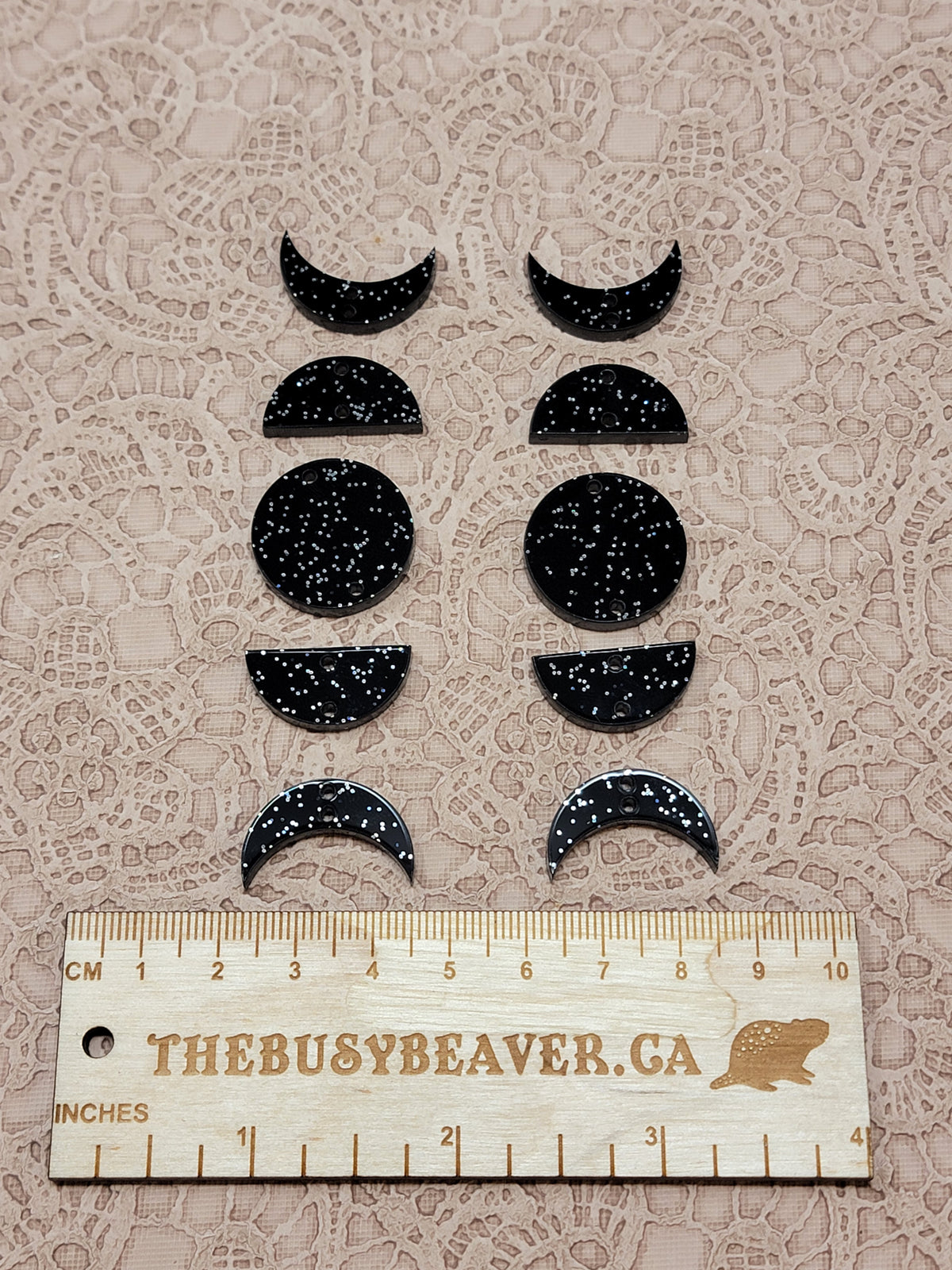 Two 5-tier acrylic moon phase sets in black glitter: crescent, half and full moons beside a ruler