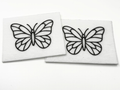 Two beading patterns printed in black on stiff white pellon squares, showing a butterfly