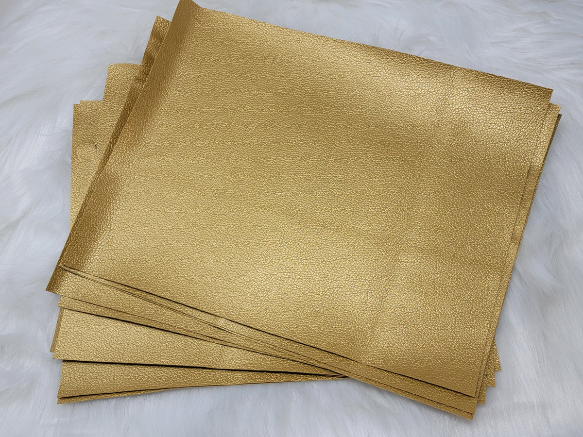 Stack of #21 gold faux leather sheets with a metallic sheen, fanned slightly apart