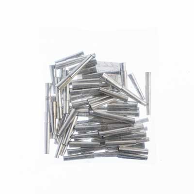 Pile of silver aluminum tube cones in mixed lengths on a white background