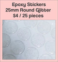 Sheet of 25mm round glitter clear epoxy dome stickers with a pink label