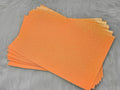 Stack of #26 orange glow-in-the-dark glitter faux leather sheets with a fine shimmer